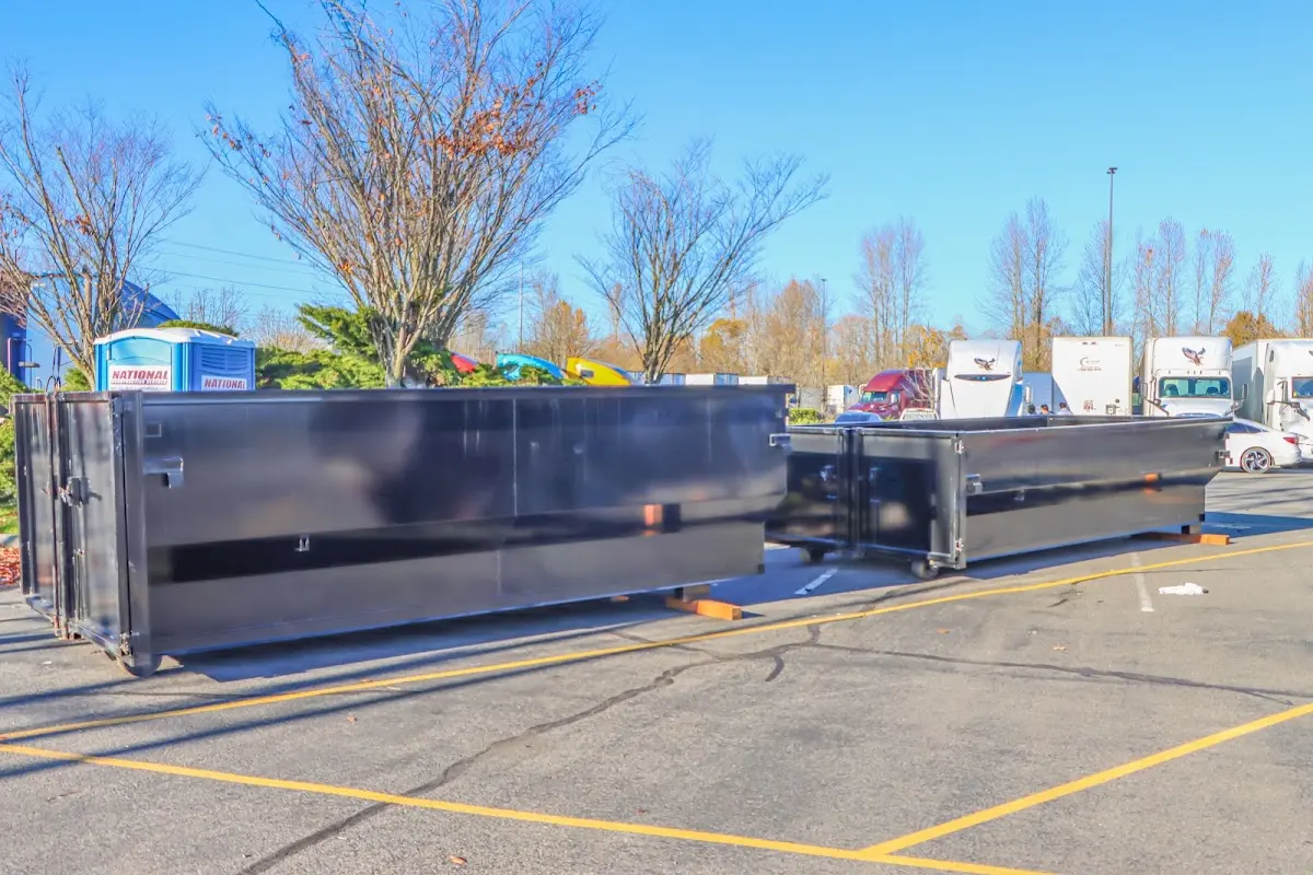 Professional dumpster rental service with roll-off container on residential driveway in Marshfield